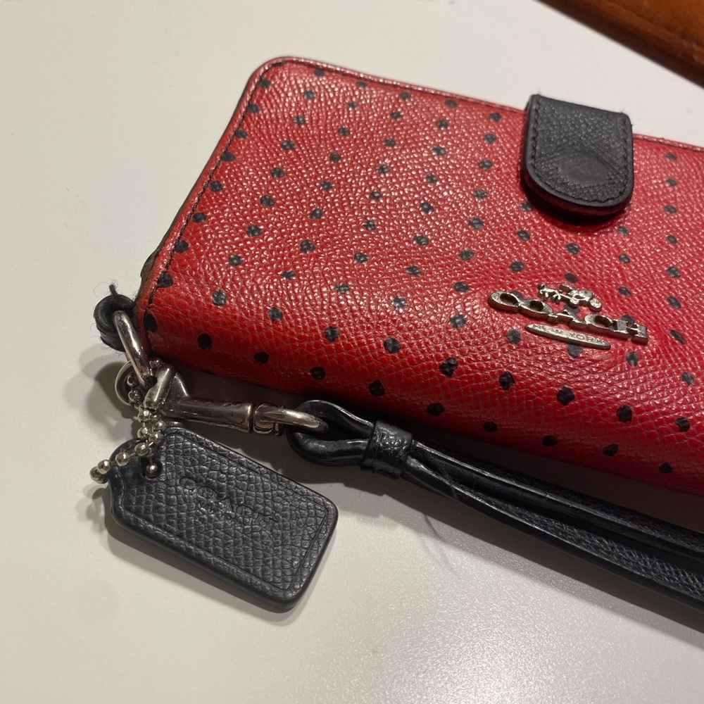 red and black polka dot leather coach wallet phone case with wrist strap